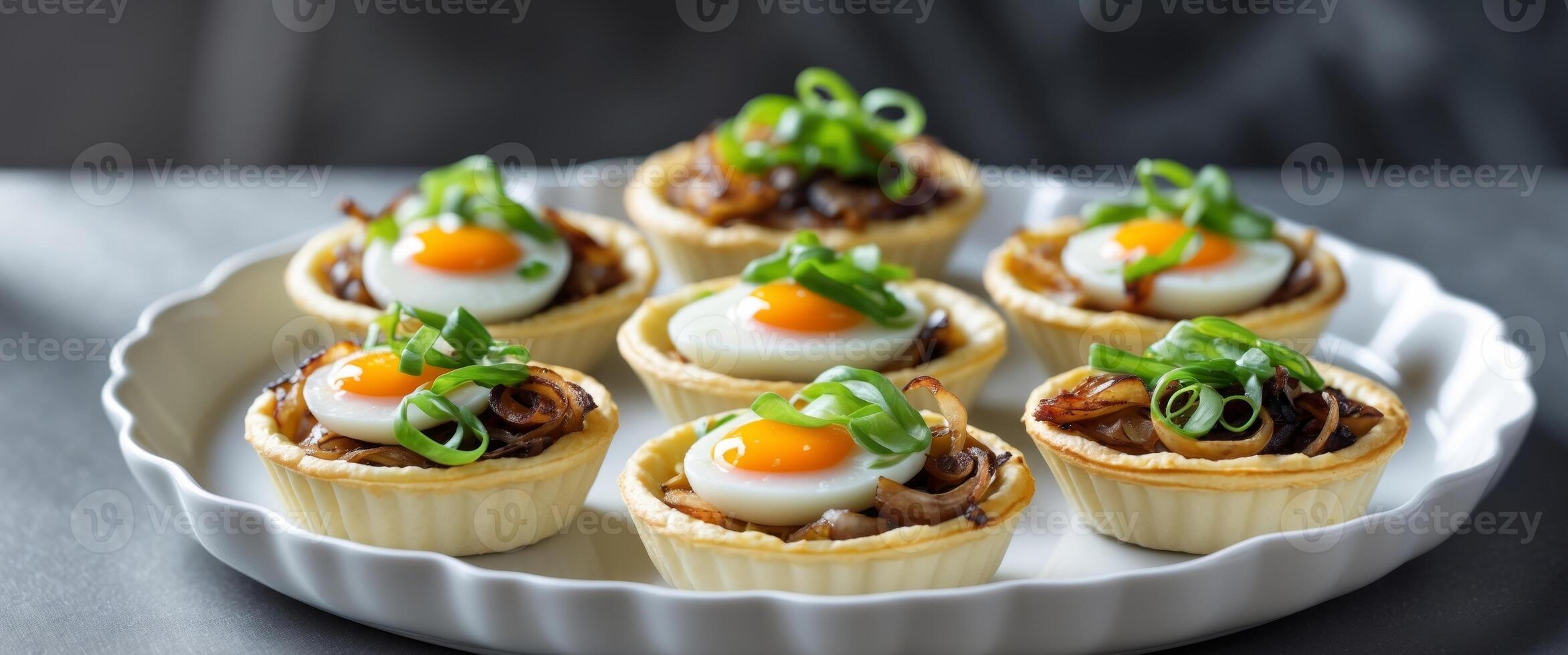 Mini Quiches with Eggs Onions and Cheese Topped with Green Onions in White Dish on Dark Background. photo