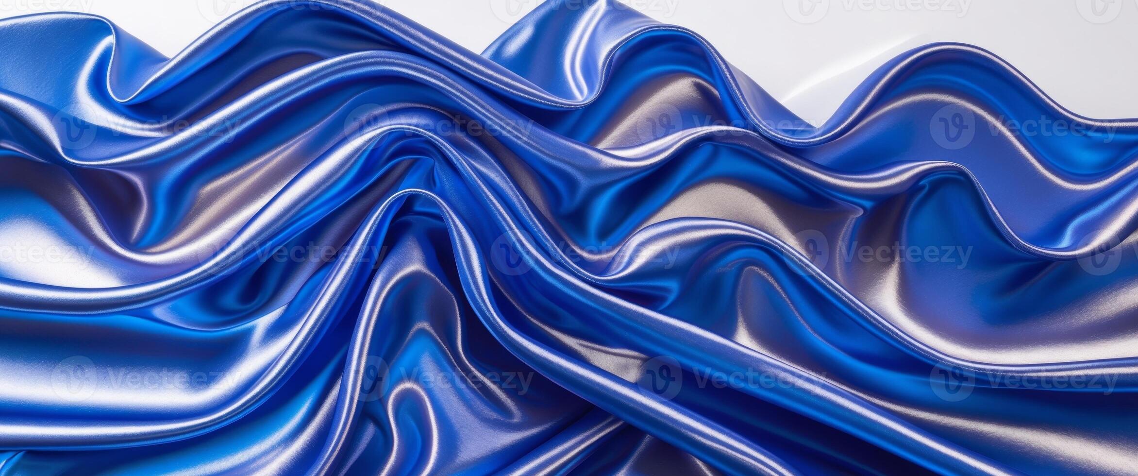 Organic Waves of Royal Blue Textile with Reflective Surface Creating Dynamic Light and Shadow Play in a Flowing Water Scene. photo