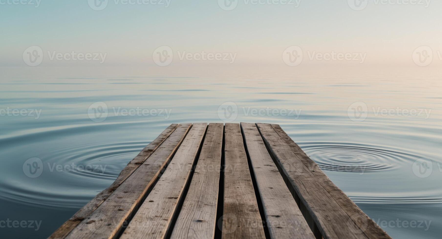 Serene Waterfront Scene with Wooden Deck and Calm Waters in Background. photo