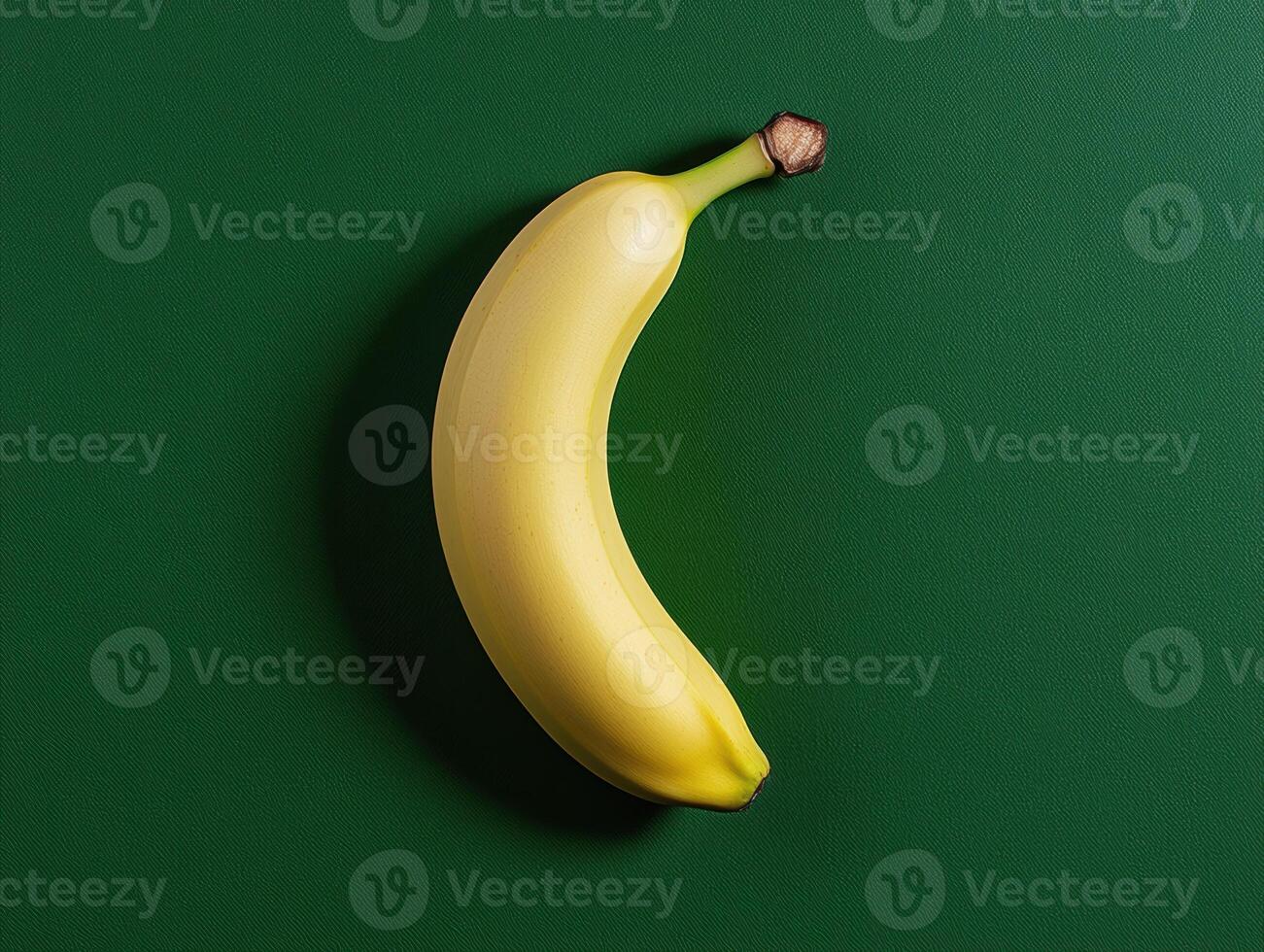 Single ripe yellow banana on green background photo