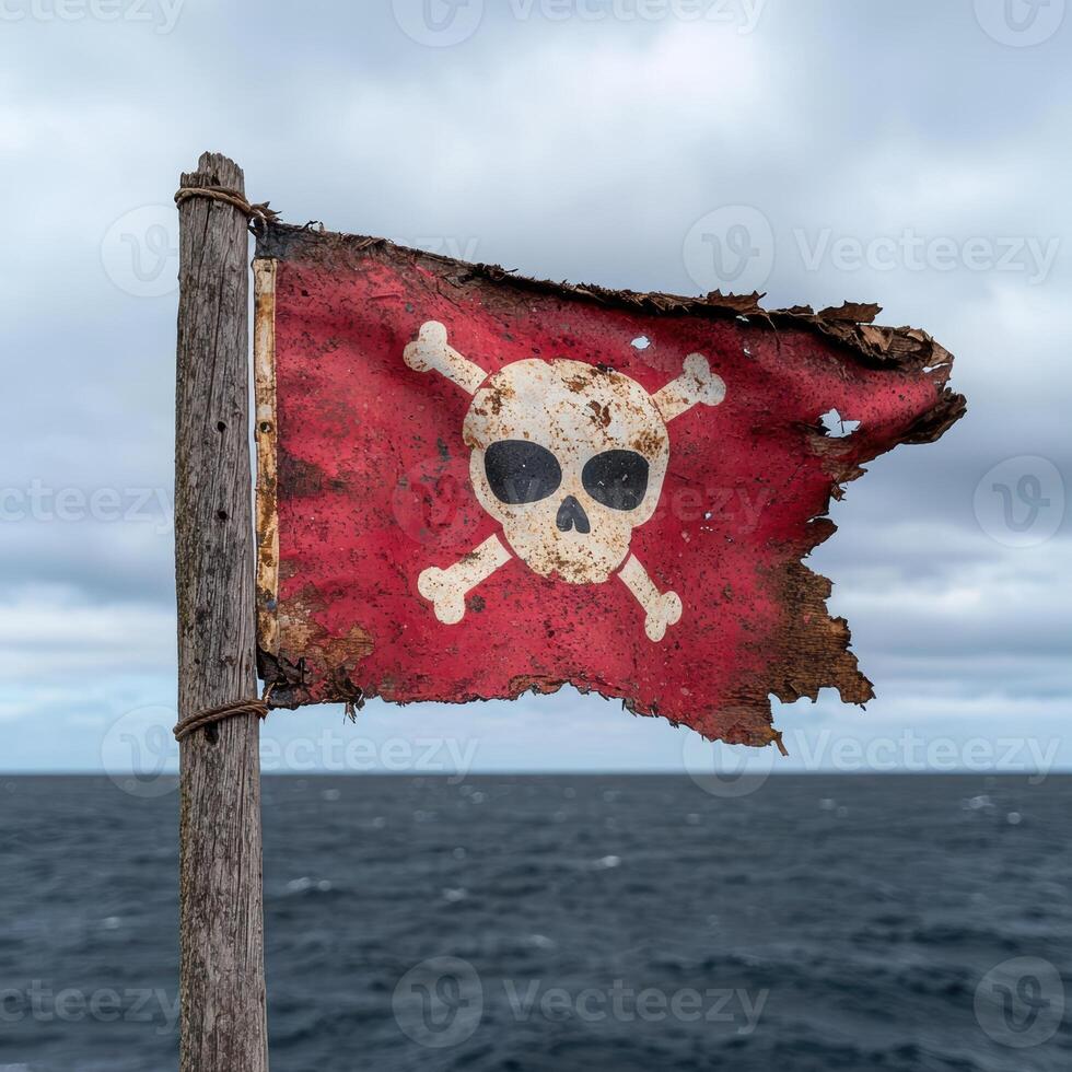 Tattered pirate flag with skull and crossbones on weathered wood post against a stormy sea photo