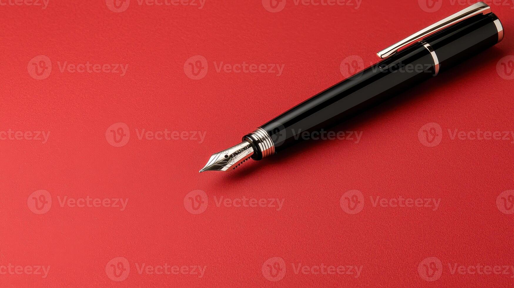 Elegant black fountain pen on red background photo