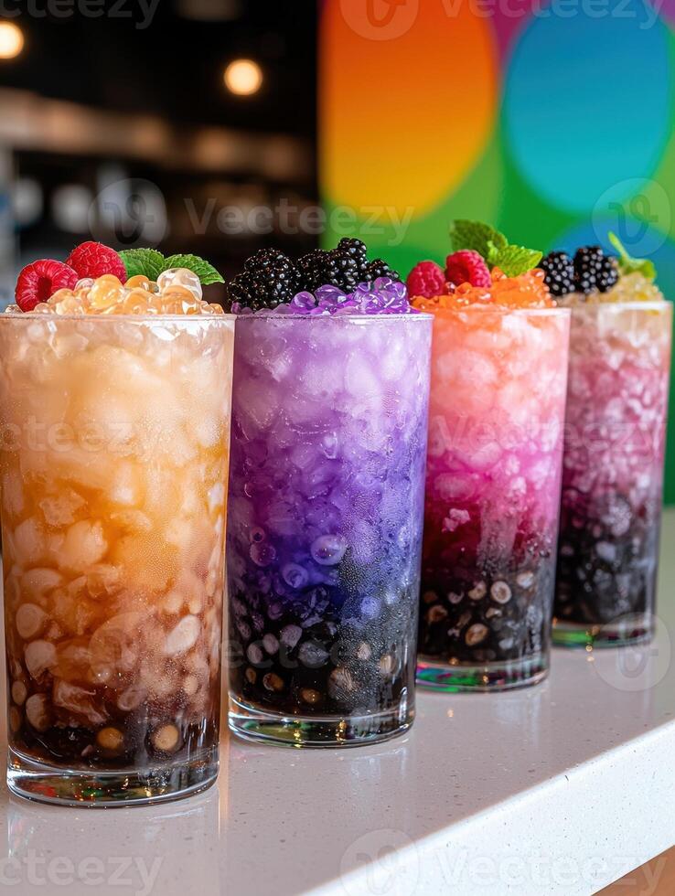 Close up of four colorful bubble tea drinks with various toppings photo