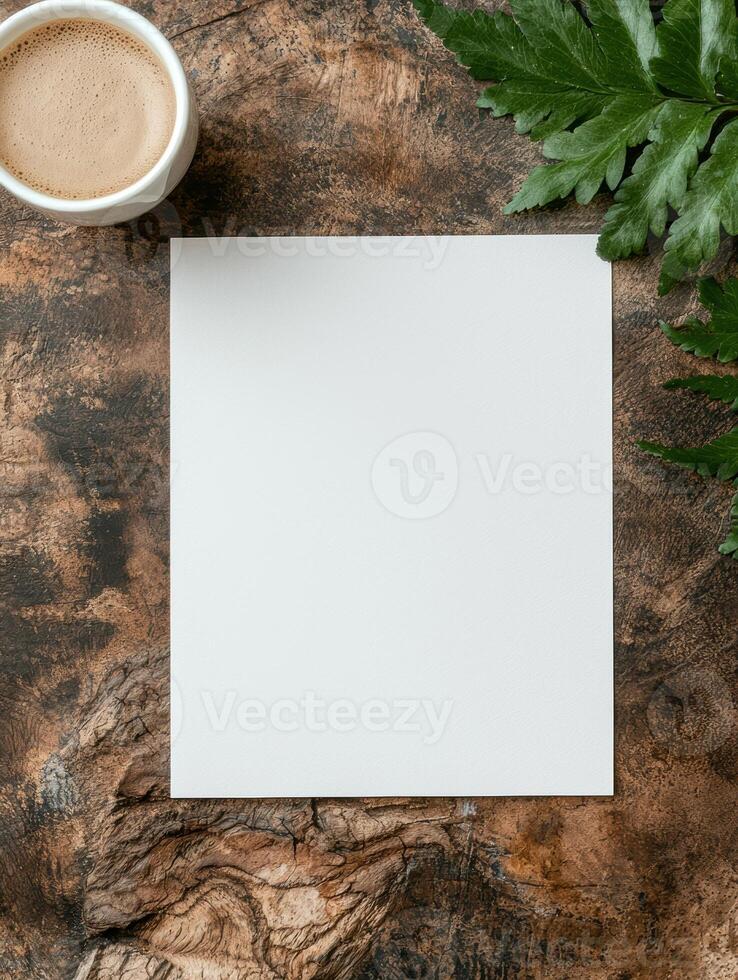 Blank paper on rustic wooden background with coffee and leaves photo