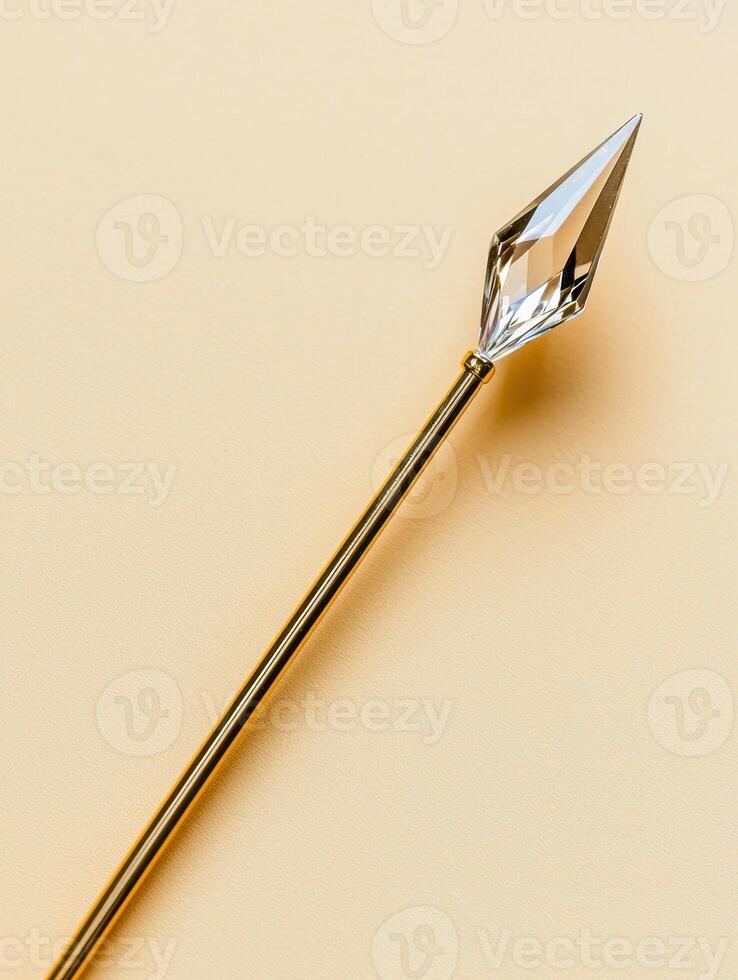 Gold wand with crystal tip on beige background photo