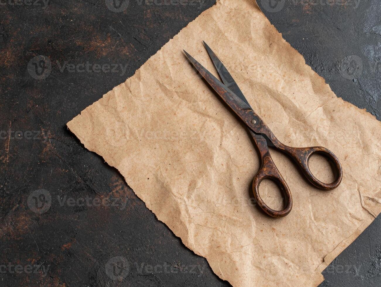 Antique scissors on crumpled paper photo