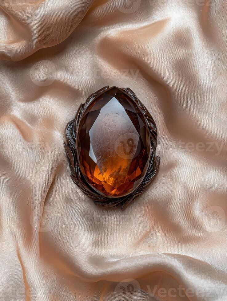 Amber brooch on silk fabric photo