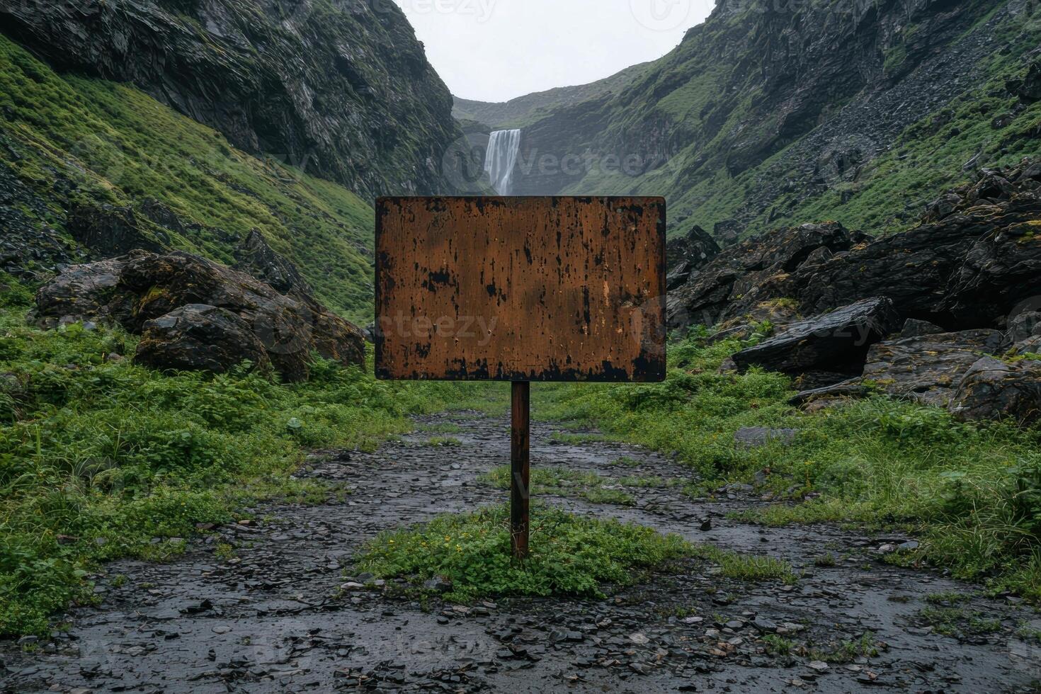 Blank weathered signpost on a mountain path photo
