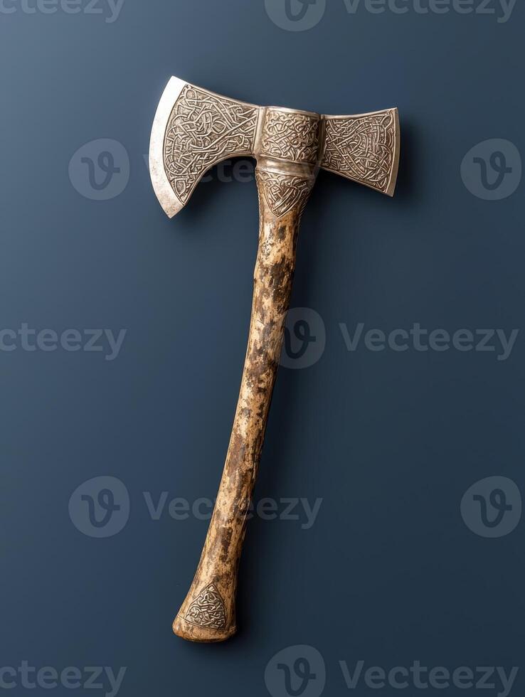 Ornate double bit axe with intricate carvings on a dark background photo