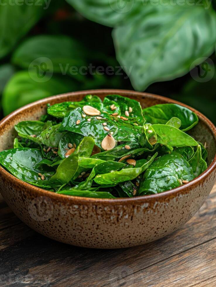 Close up of a delicious spinach salad with sesame seeds and almonds photo
