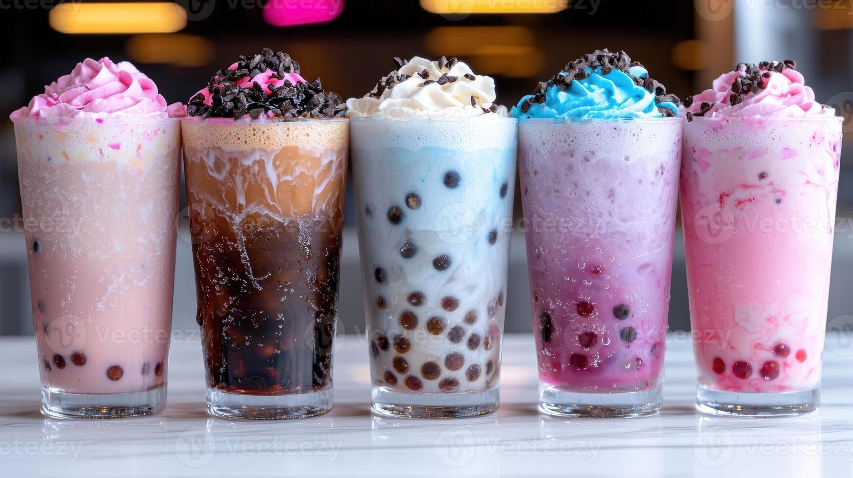 Five colorful bubble tea drinks with whipped cream and toppings photo