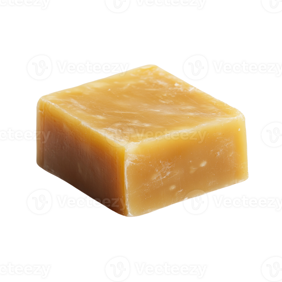A single cube of amber colored soap sits on a black background png