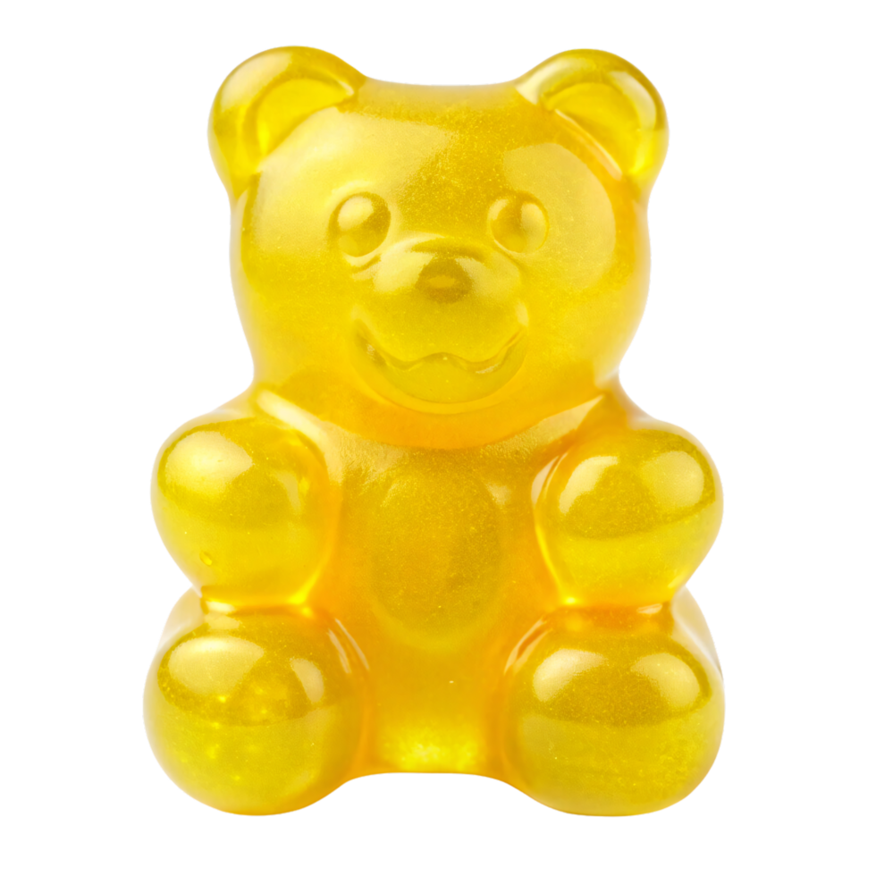 A shiny, yellow gummy bear sits upright, showcasing its translucent, jiggly texture with rounded limbs, a cute face, and an inviting smile png