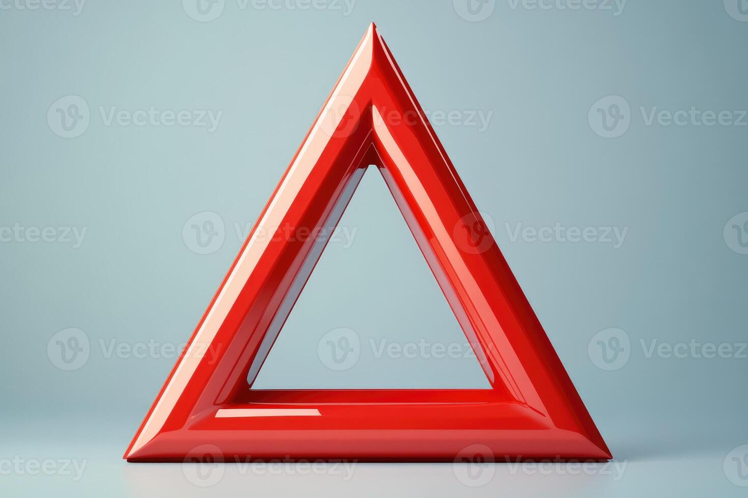 Red triangle standing on light blue background representing danger or warning photo