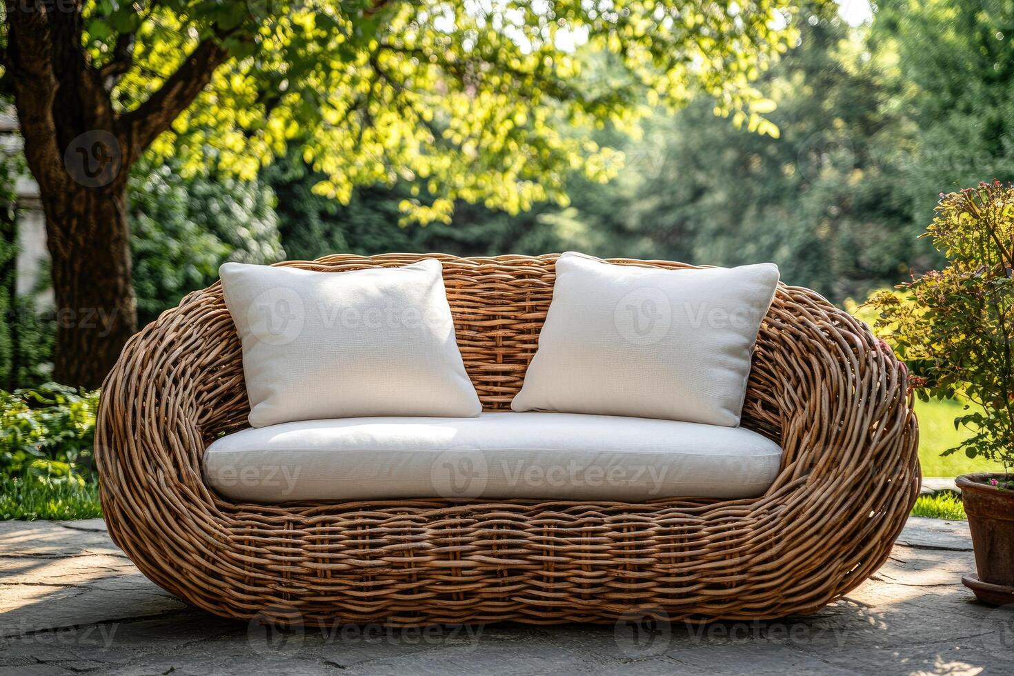 Comfortable wicker sofa inviting relaxation in lush green garden. photo