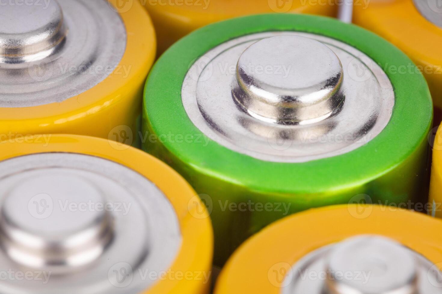 Close up of colorful AA batteries in a row photo