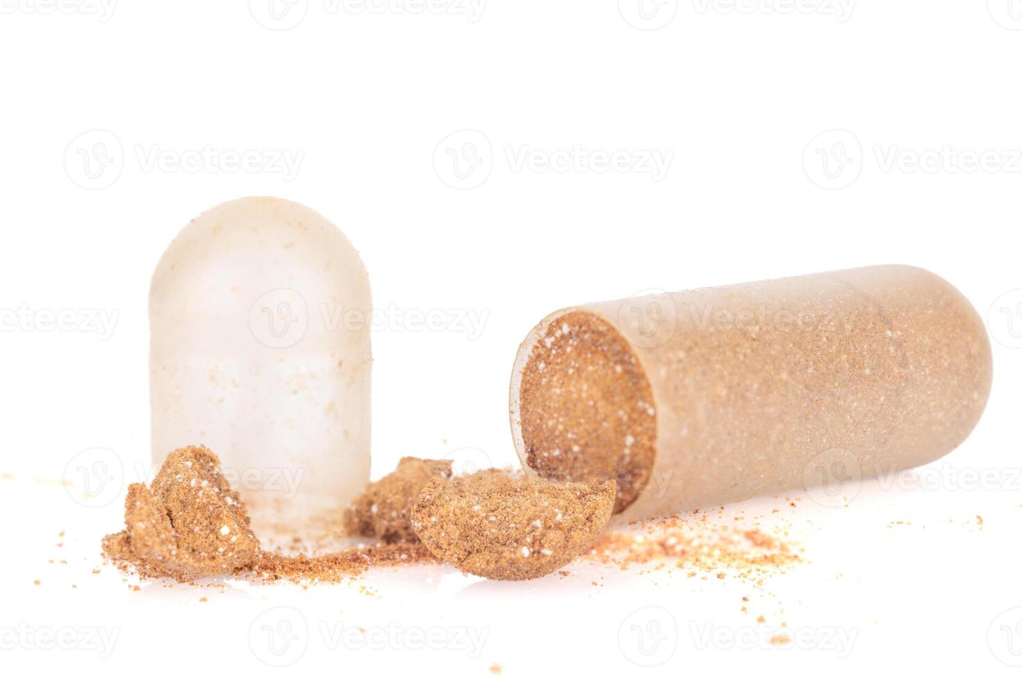 Expired and Hardened Capsule with Spilled Powder on White Background photo
