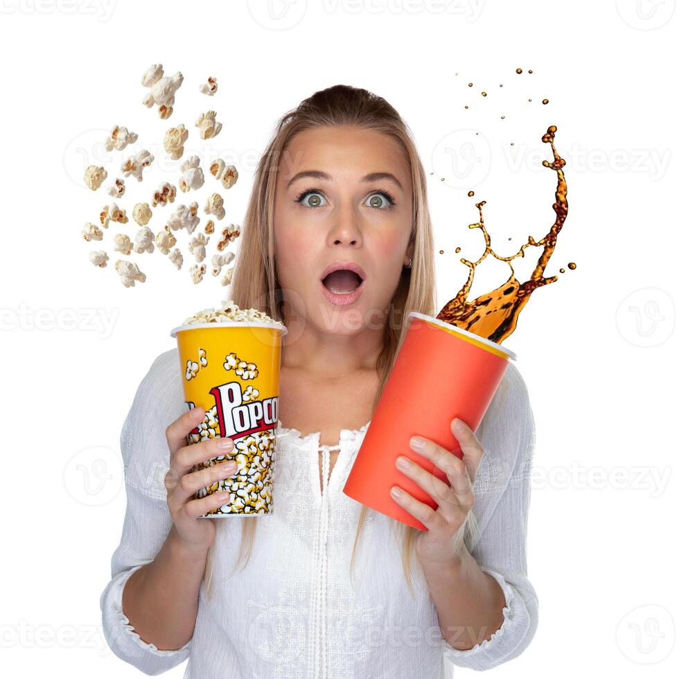 Excited Young Woman Enjoying Popcorn and a Refreshing Drink at the Movie Theatre photo