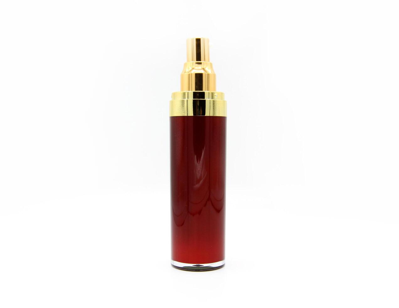 Red and golden cosmetic bottle isolated on white background. Container and object design to contain cream, liquid or moisturizer photo