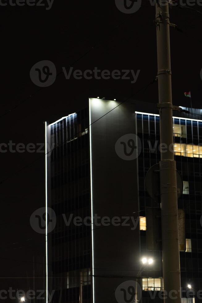 Illumination of a tall building in Minsk. University building at night photo