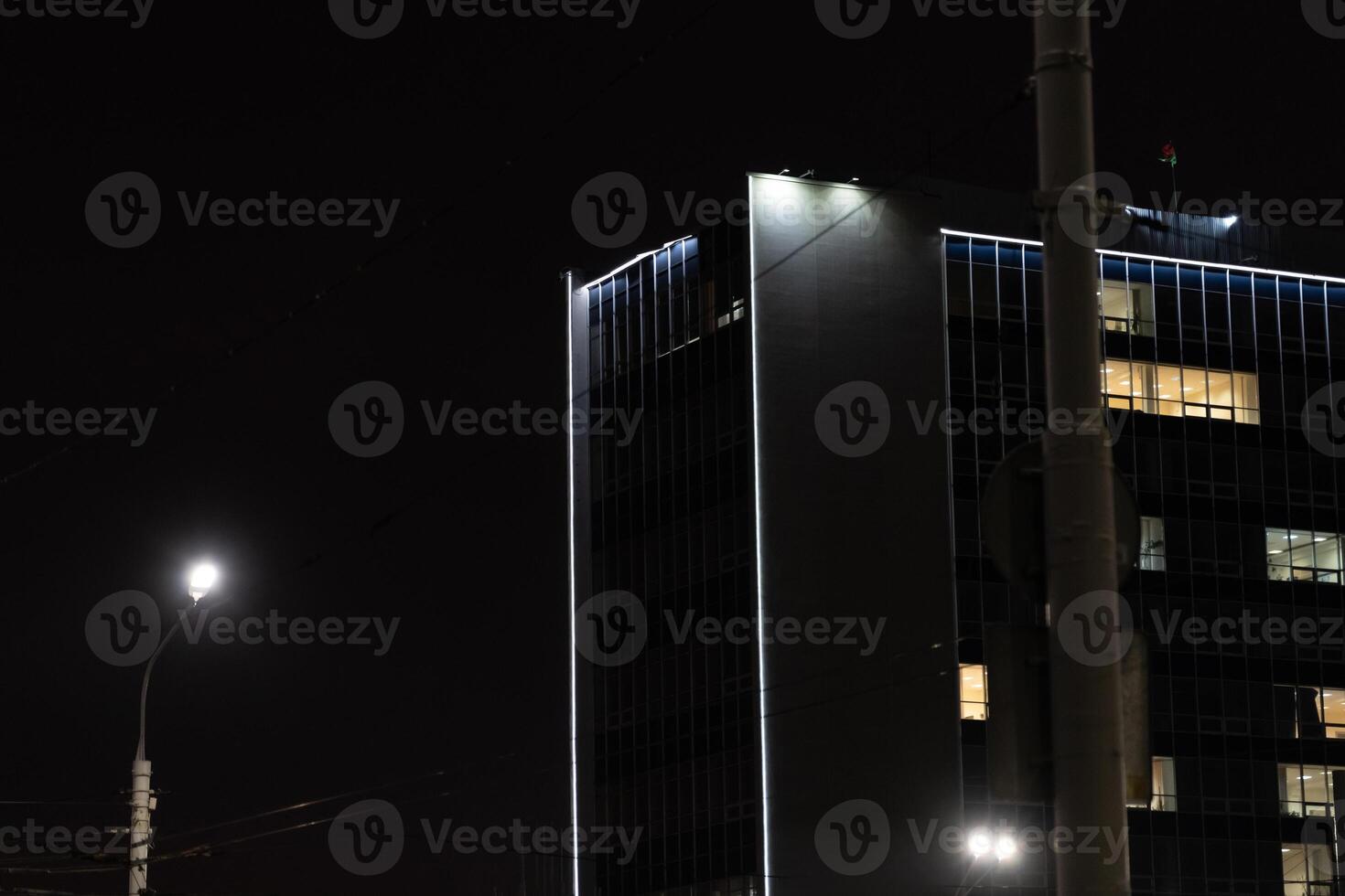 Illumination of a tall building in Minsk. University building at night photo