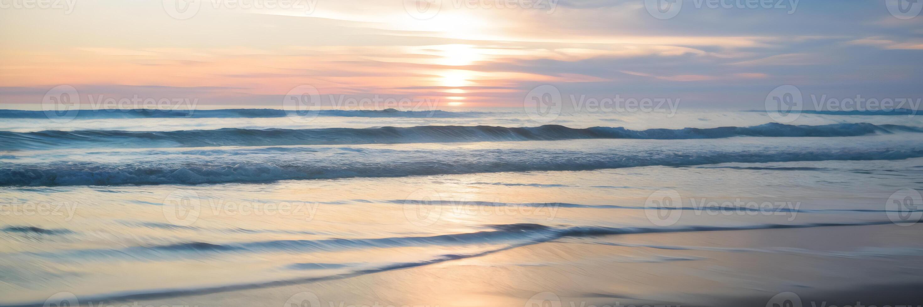 Blurred sunset at beach with warm light and gentle bokeh from waves photo