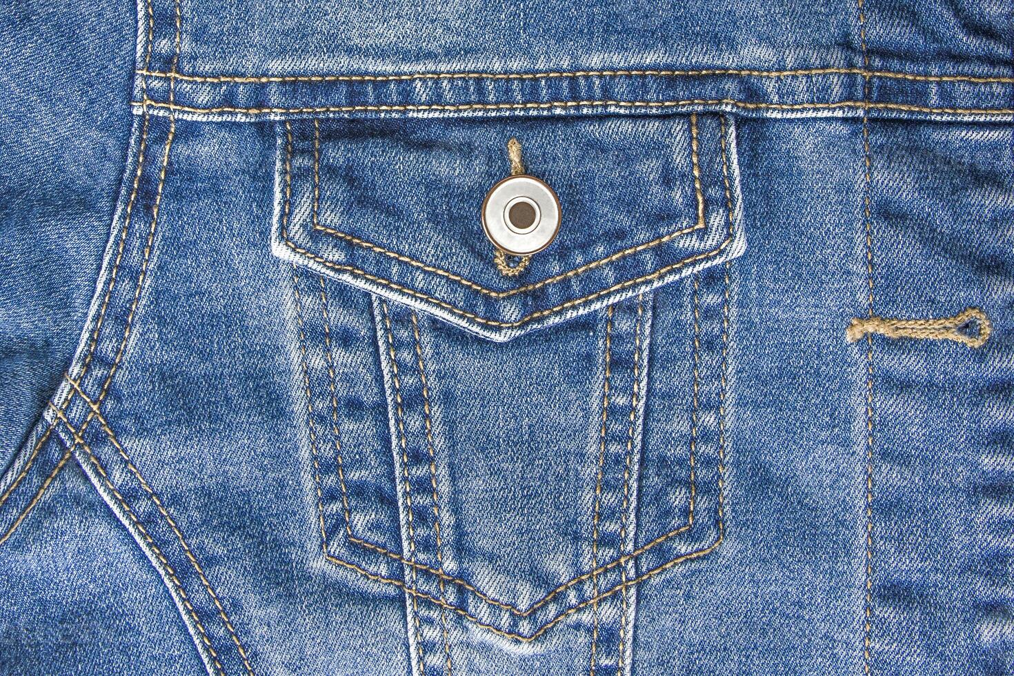 light blue denim pocket with button background photo