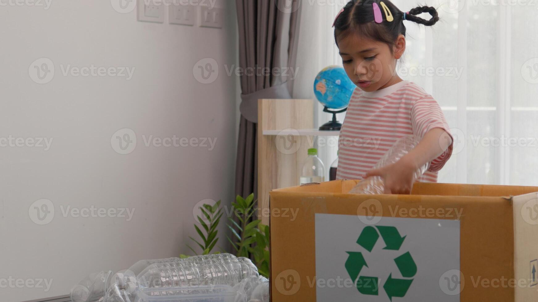 Asian little Girls dump plastic bottles in recycling boxes to reduce trash, reuse, and recycle. Recyclability and sustainability photo