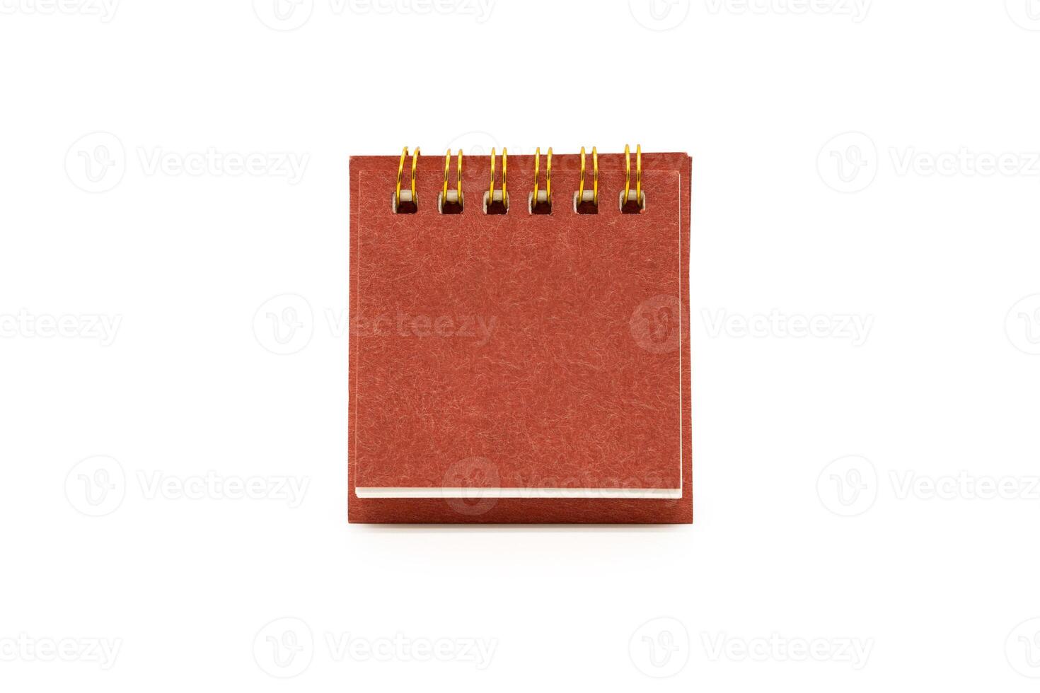 Blank red desk calendar isolated on white background. Blank paper desk spiral calendar. Copy Space and clipping path. photo