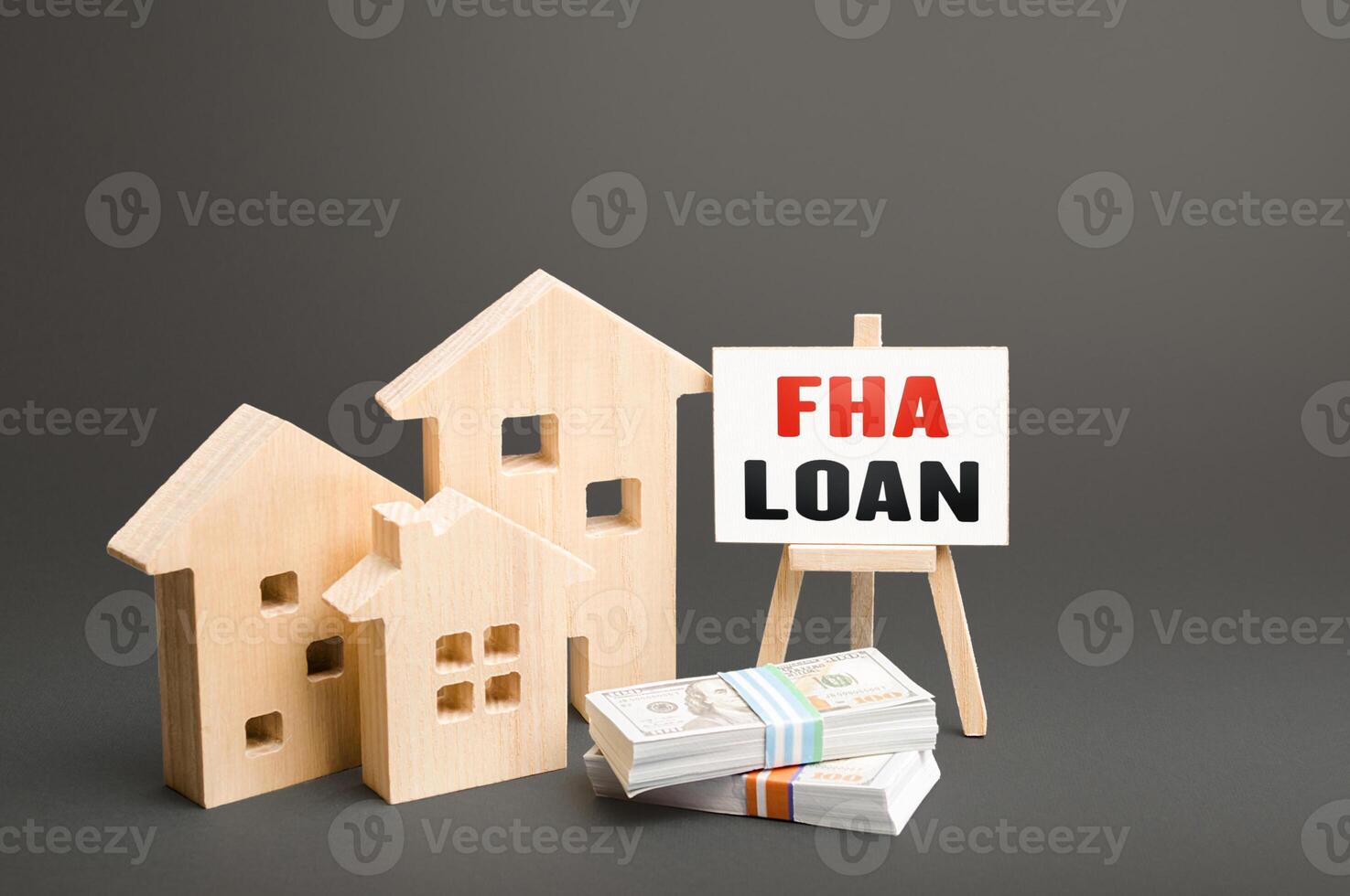 Residential buildings and easel with FHA loan. Mortgage insured by Federal Housing Administration Loan. An affordable financial instrument for borrowers with a low credit score. High risk of default photo