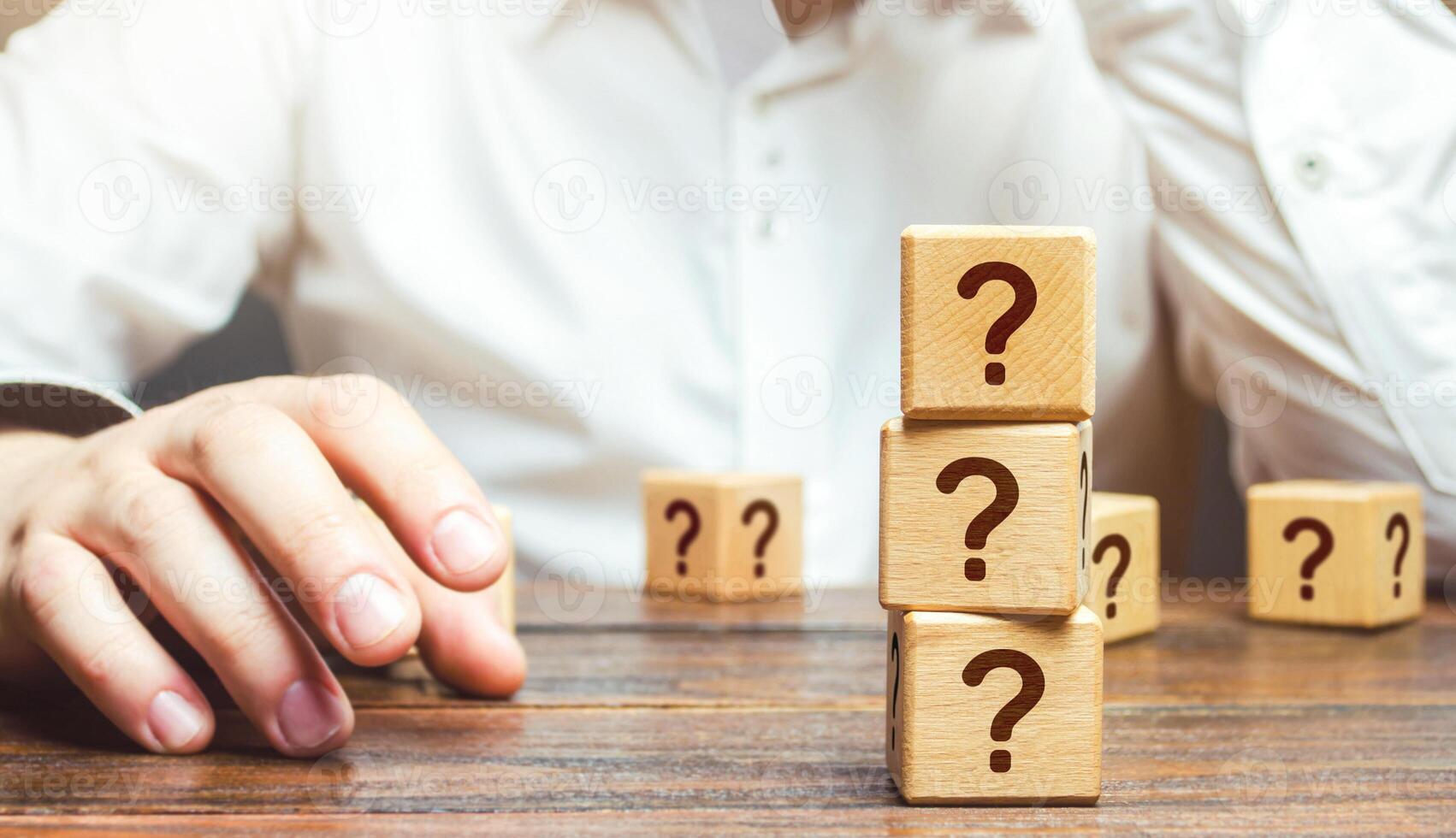 Man is in thought and blocks with questions. Pondering the problem, gathering all the facts. Make the right decision. Reasoning, weighing results and consequences. Reflection and planning. Strategy. photo
