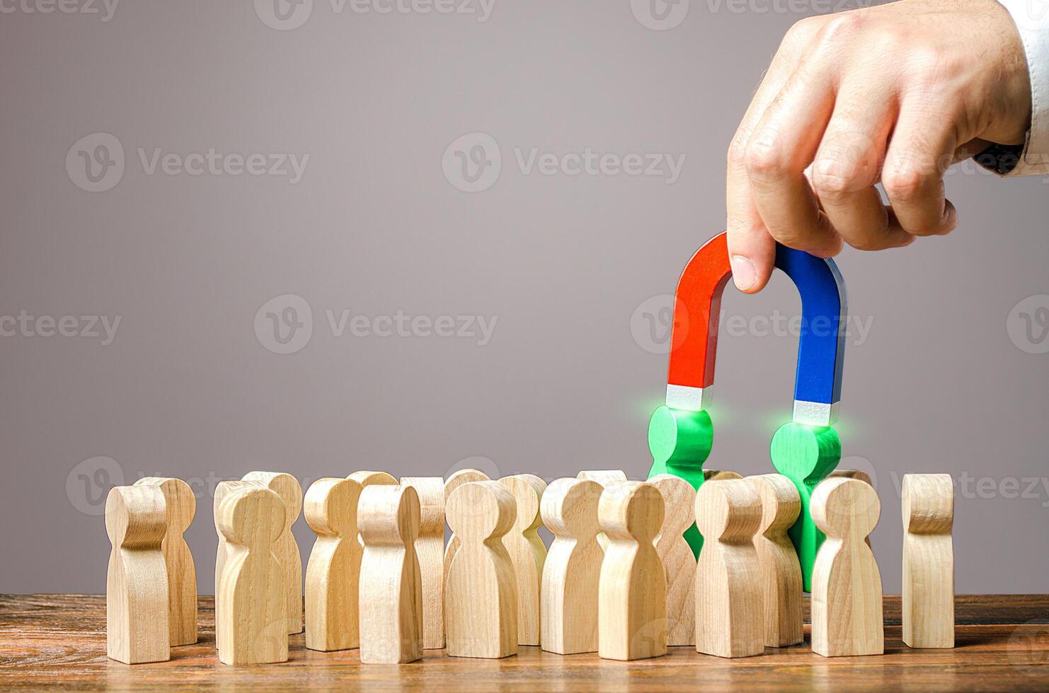 Employer recruits employees with a magnet. Hiring staff from a quality human resource. Professional job candidates. Employment of talented workers. Identifying people with skills, leadership qualities photo