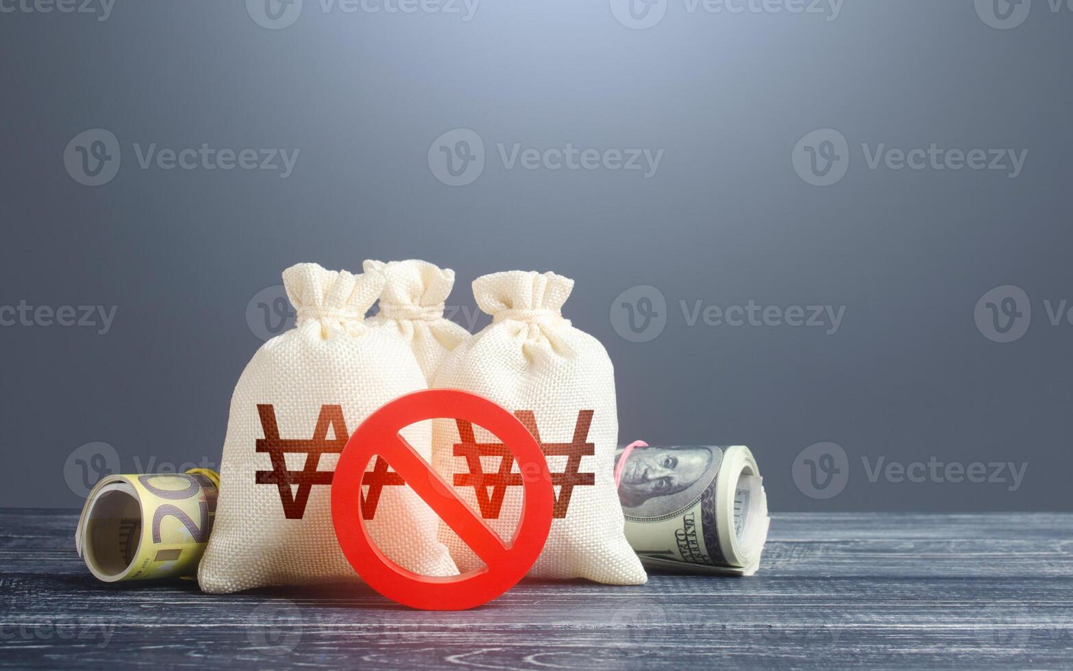 South korean won money bags and red prohibition symbol No. Sanctions. Economy crisis. Freezing assets, banning transactions. Capital export outflow restrictions. Urgent stock market close. photo
