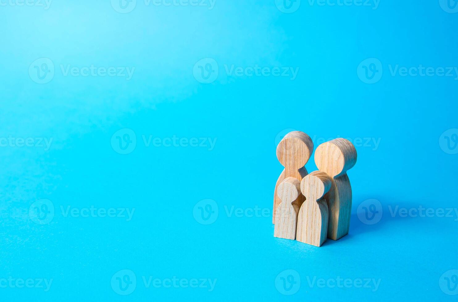 Family figures of parents and kids on a blue background. Family values and health photo