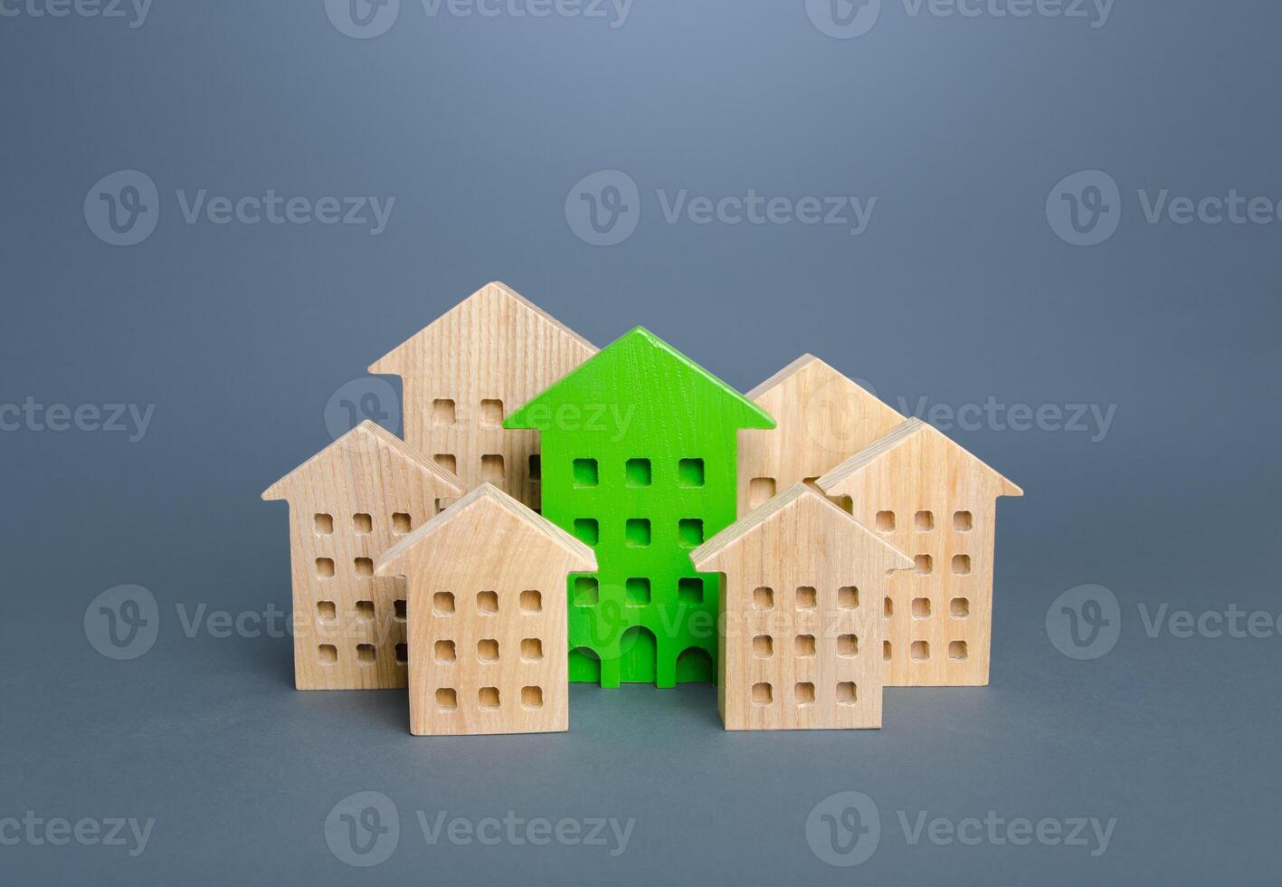 The green building stands out among the houses. Environmentally friendly, energy efficient and zero carbon emissions. Search for the best option to buy an apartment. Net Zero Carbon neutrality. photo