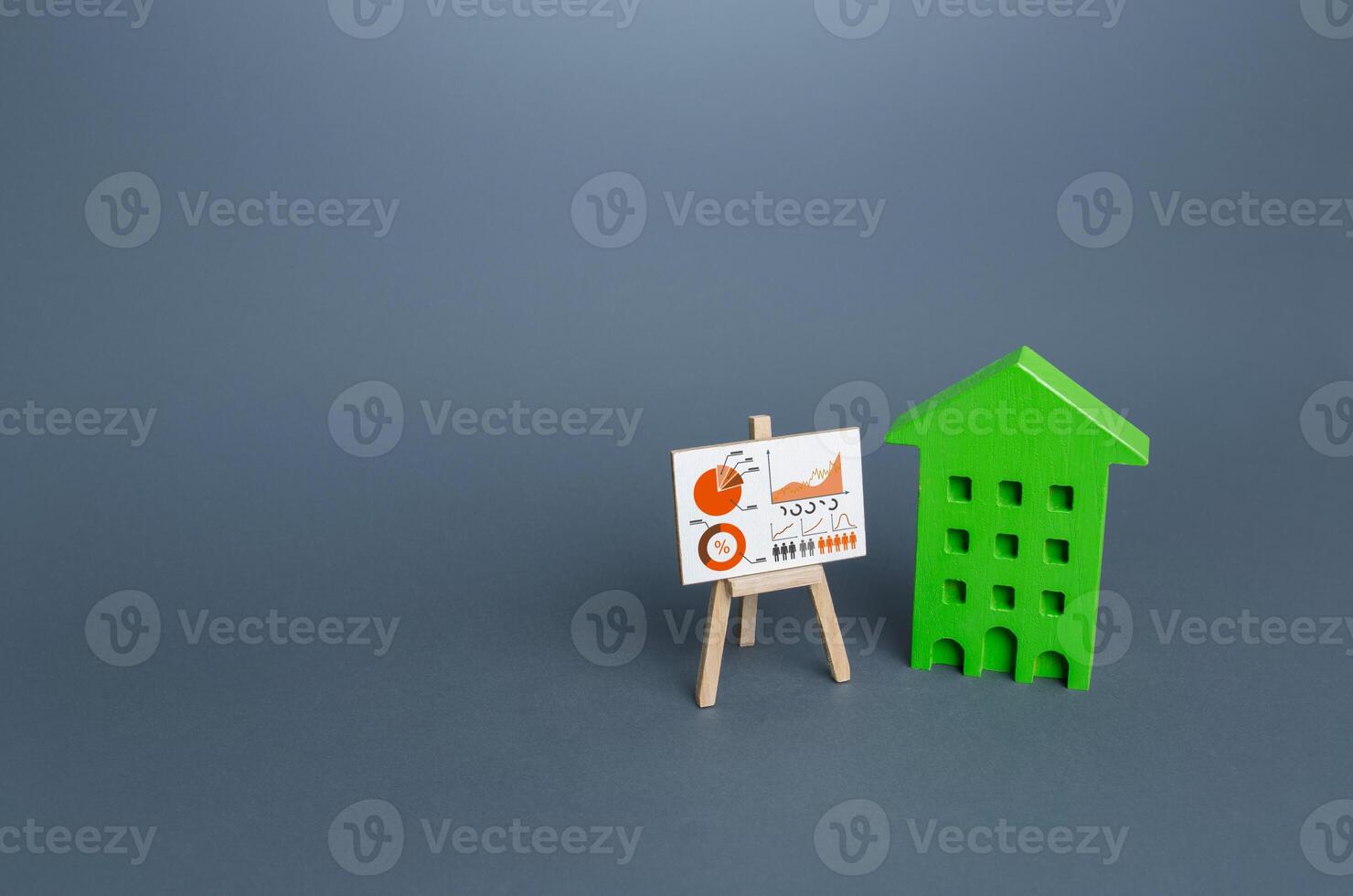 Green house and easel with infographics. Statistical information on resource consumption, waste production. Environmentally friendly, zero carbon emissions. Improving utilities energy efficiency photo