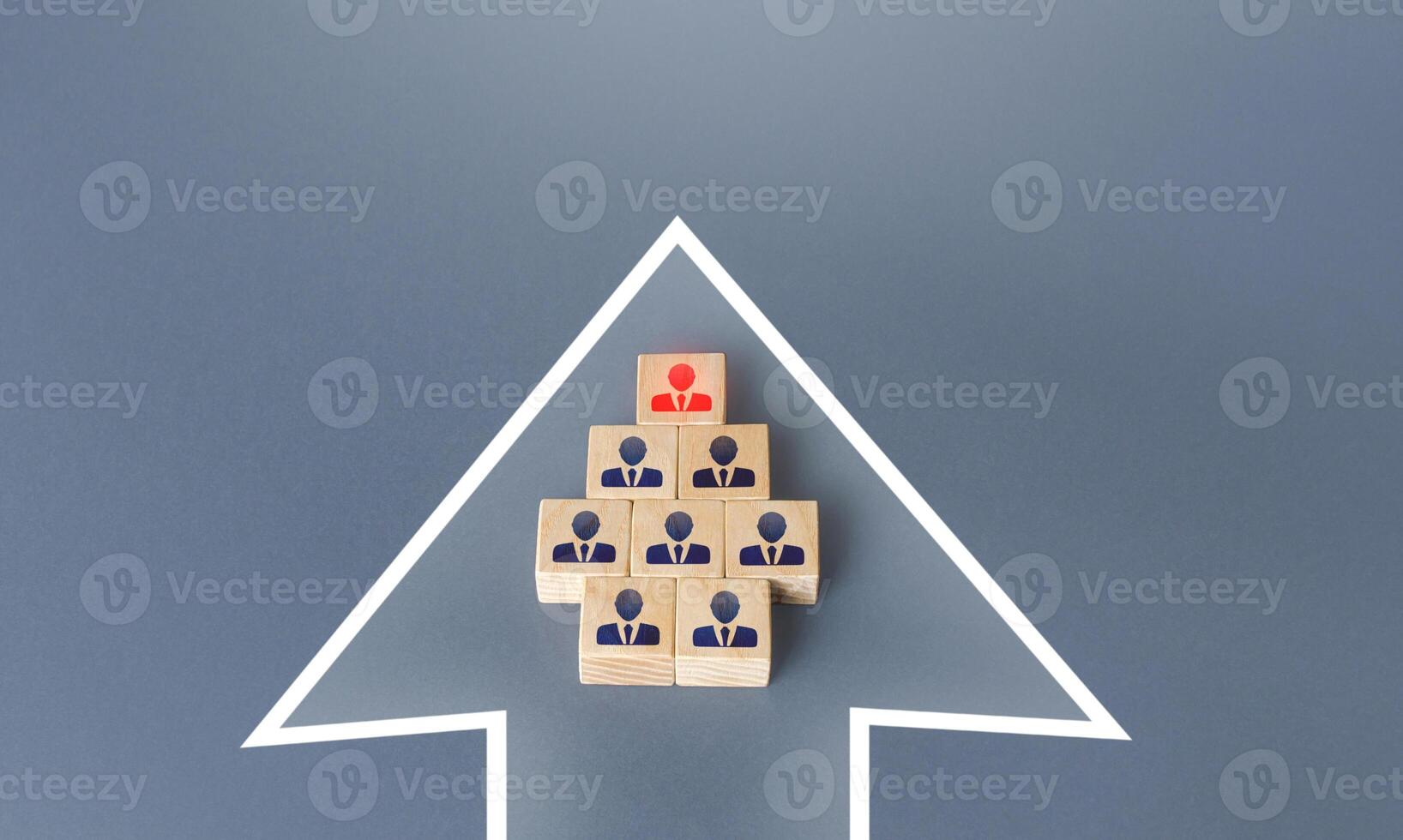 Business team group of people made of blocks in the direction arrow. Teamwork. Formation of an organized group for the cooperative achievement of the goal. Follow the planned development . photo