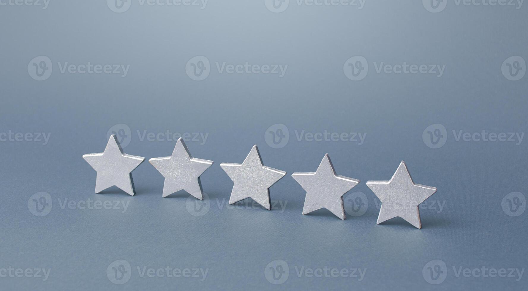 Five gray stars. Rating evaluation concept. Service quality. Buyer feedback. Popularity rating of a restaurant, hotel or mobile software applications apps. High satisfaction. Good reputation status. photo