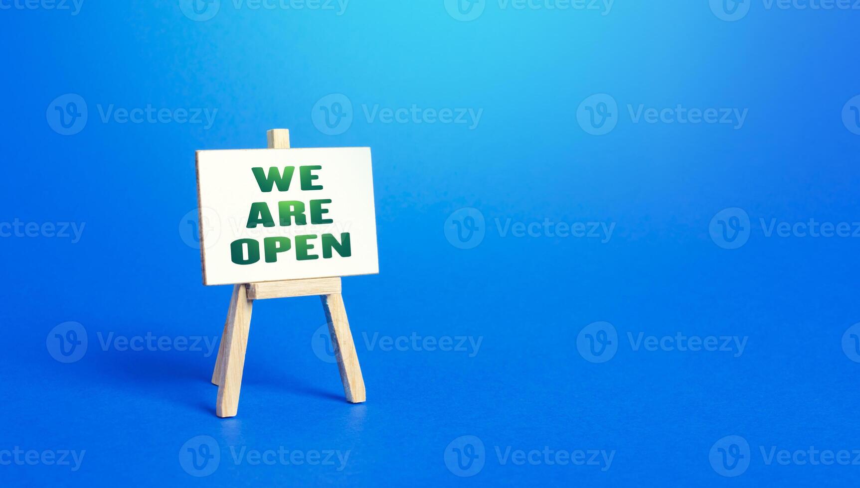 We Are Open easel sign. Exit from severe quarantine conditions, economic and business recovery. Return to normal life. Adaptation to rules. Business flexibility and readiness for new challenges. photo