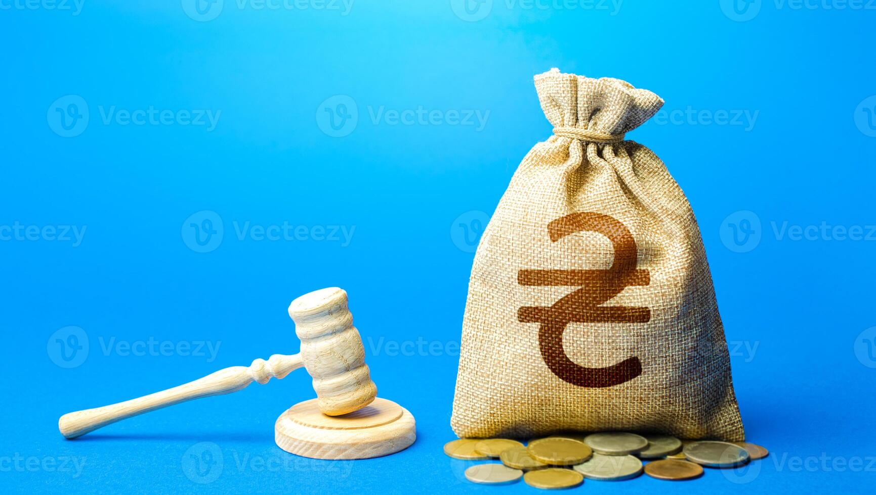 Ukrainian hryvnia money bag and judge's gavel. Litigation, dispute resolution, conflict of interest settlement. Protection rights. Justice. Lawyer services. Awarding moral financial compensation. photo