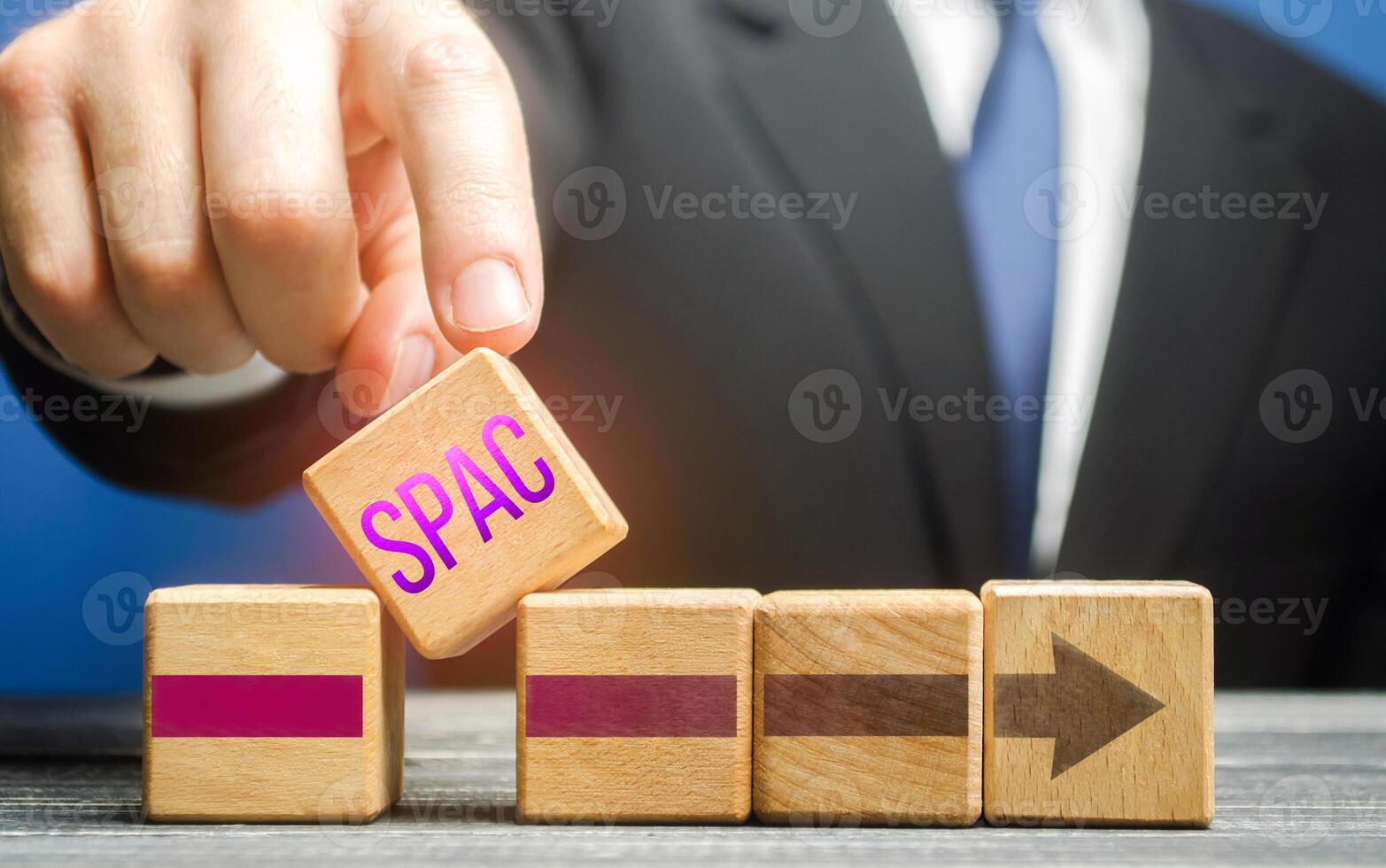 Man introduces a block with a word SPAC in a row. A easy way stock exchange financial instrument for attracting investments, sale stock bonds instead IPO. Accelerating company development process photo