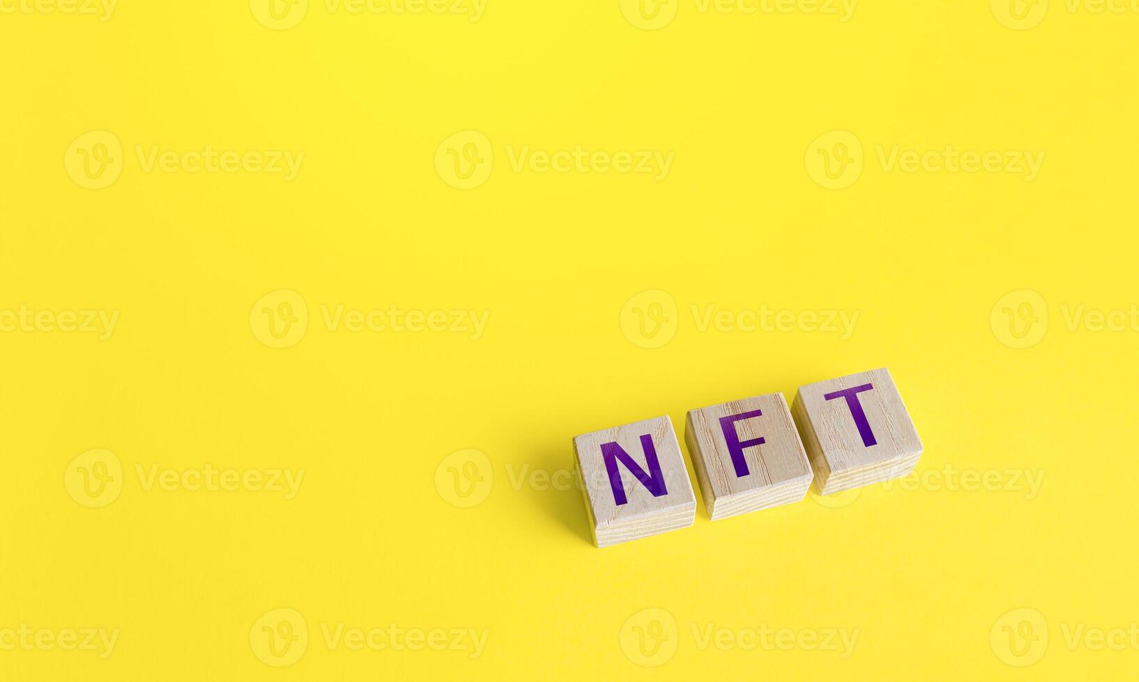 NFT non-fungible token word blocks. Selling digital assets and art through auctions. Monetization, investment in cryptographic tokens, cryptocurrency. Blockchain technology. photo