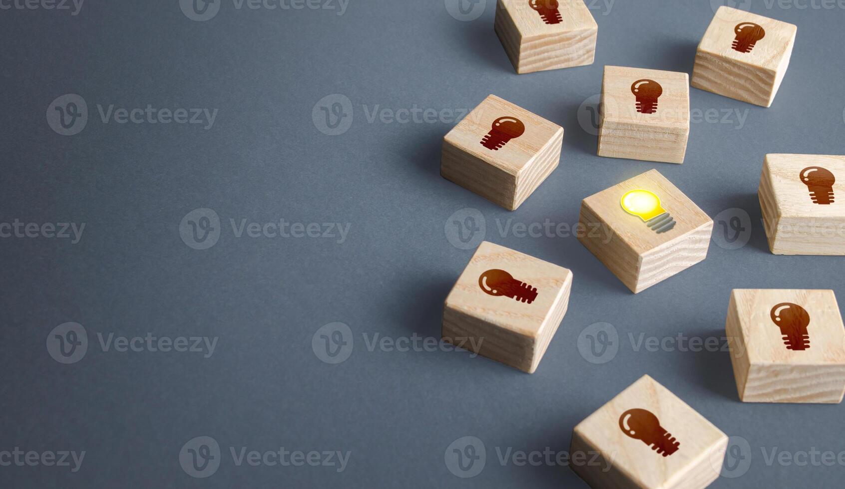 One glowing light bulb idea among many dark off. Concept choosing best suitable idea from presented. Developing startup. Business accelerator. Innovation promising technologies. Search for talent. photo