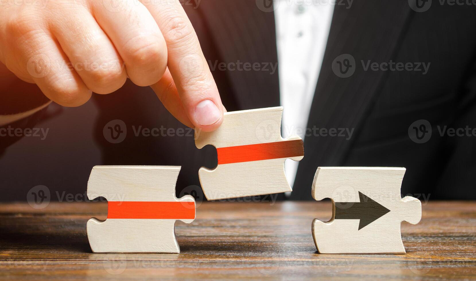 Businessman inserts the puzzle and completes the assembly of the red arrow. Business process formation. Roadmap agreement. Resuming and ensuring uninterrupted technological operation. Progress photo