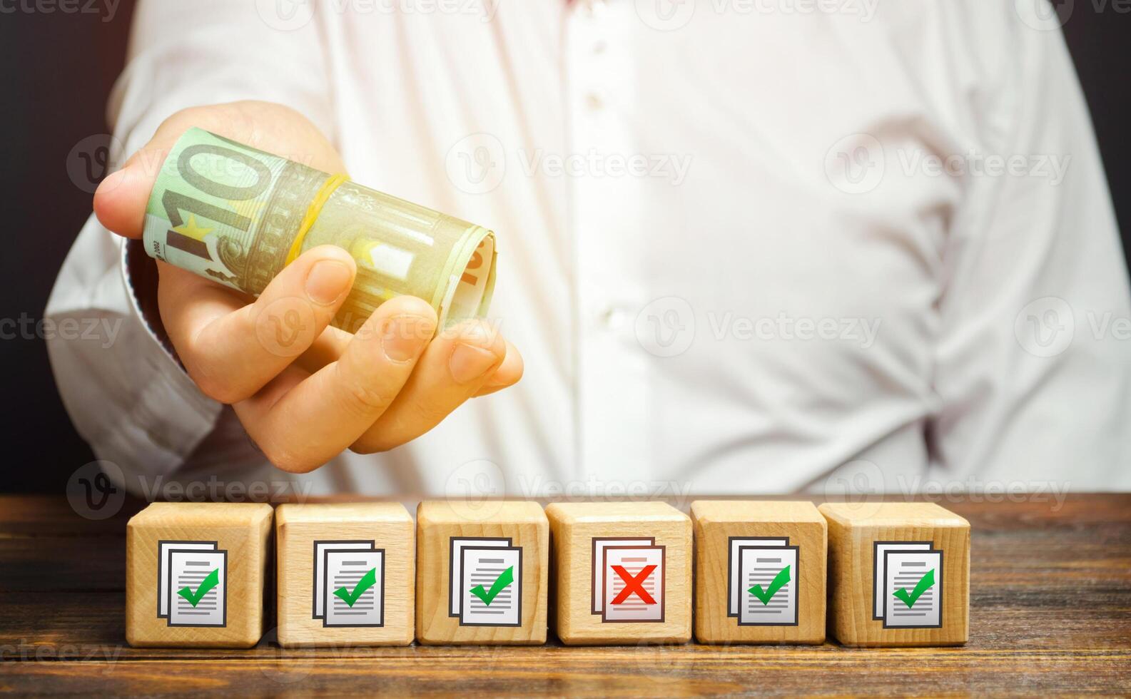 Man holds euro money above of blocks with permits documents. Bribe to obtain missing permits. Contract terms violation. Artificial bureaucratic obstacles, corruption risks, non-transparent legislation photo