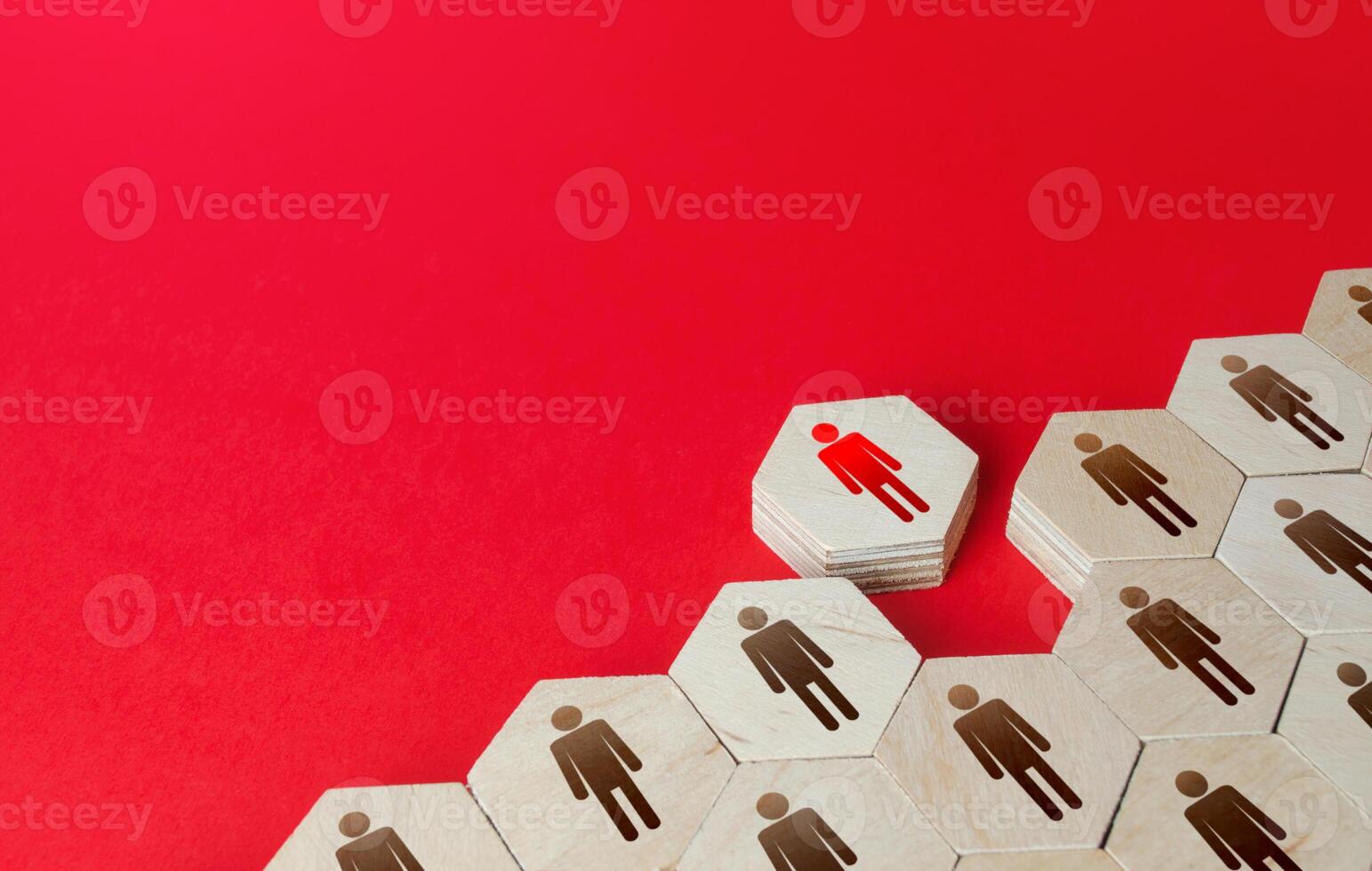 A man leaves a formation of people figurines hexagons. Violation of the integrity of the system, non-conformist. Integration of a person into society. Staff recruitment, recruiting. Exception from photo