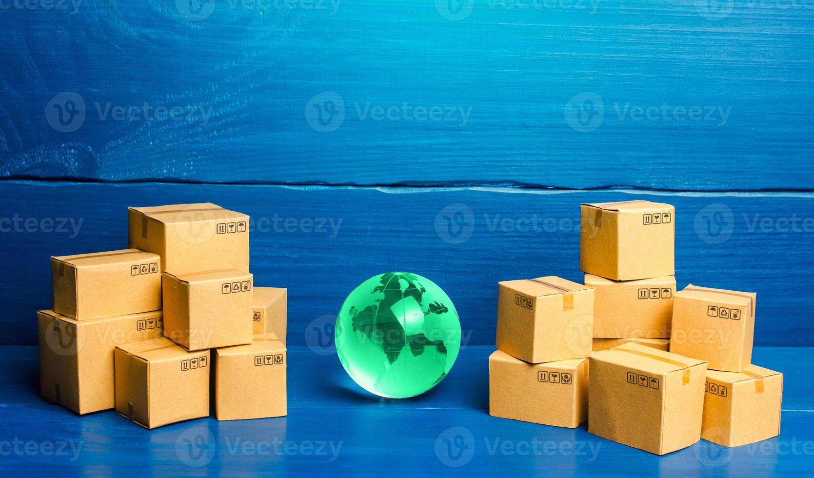 Planet Earth globe and cardboard boxes. Delivering goods and products around the world. International trade and transportation of goods. Shipping freight. Transnational business and industry. photo