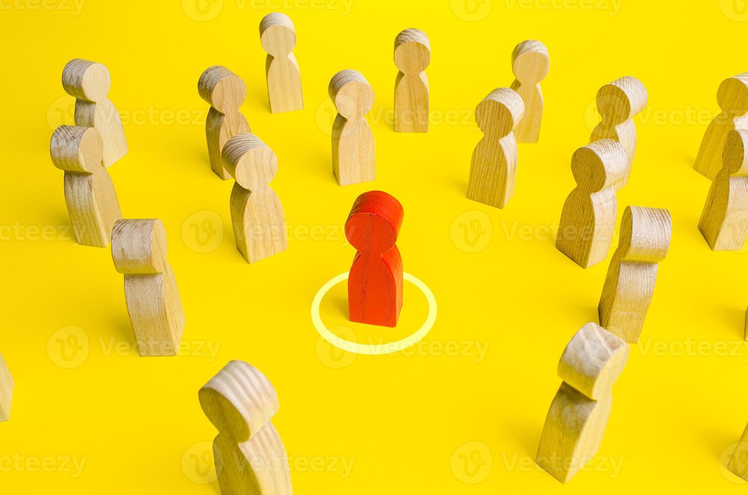 Red figurine of a man in a circle in crowd of people. Personal space, comfort zone. Maintaining distance to avoid contact and infection. Identification of infected persons and isolation from society. photo