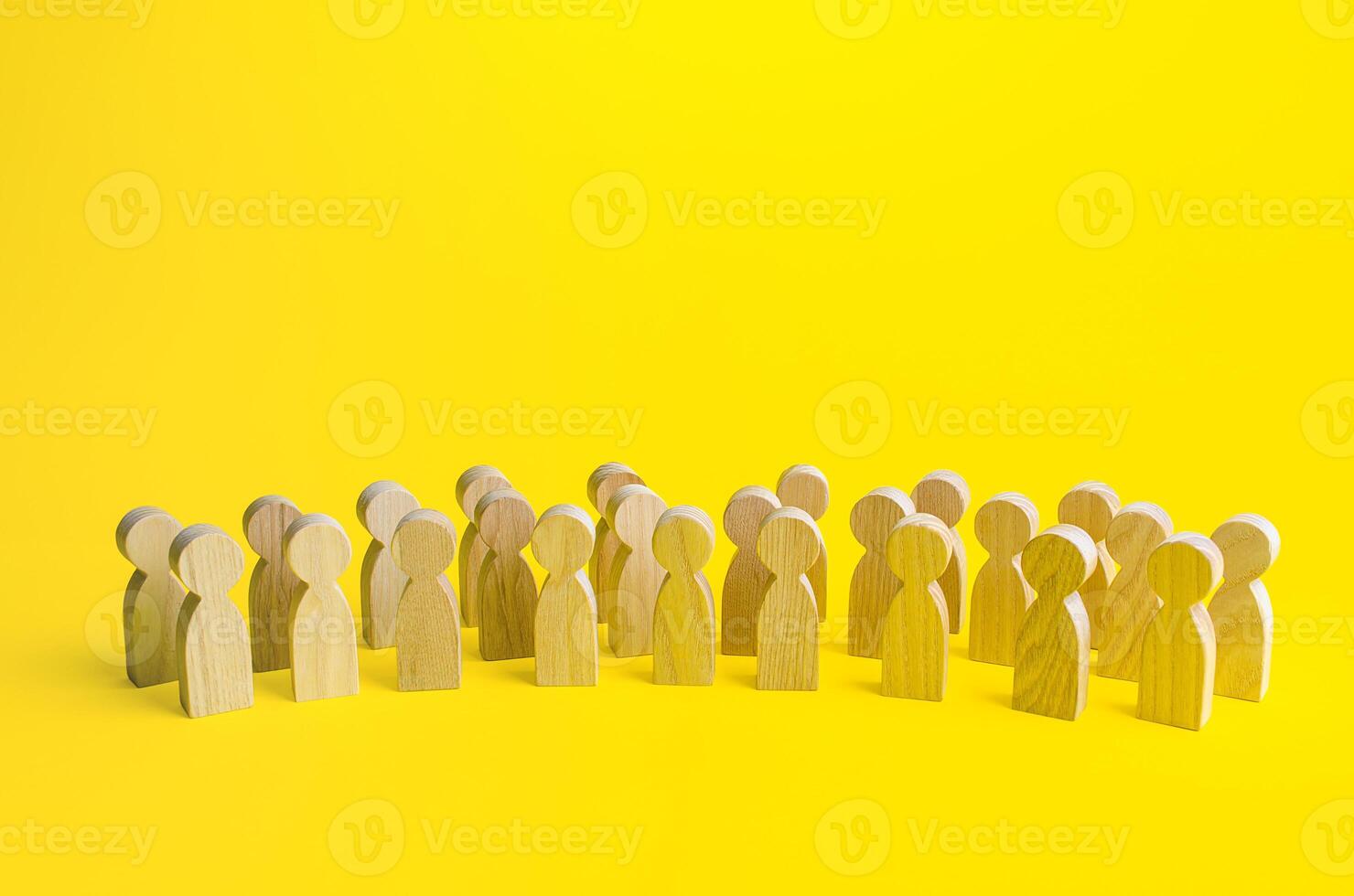 A large group of figurines of people on a yellow background. Social survey and public opinion, electorate. Population and citizens. Human resource, search for candidates. Personnel Management. photo