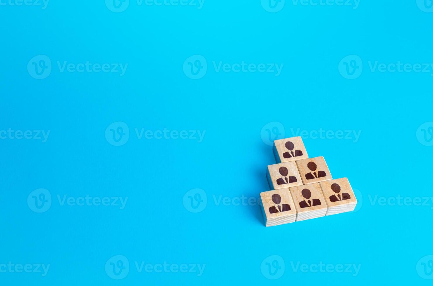 Wooden block people pyramid. Structure of organization, vertical of company power. Grouping, distribution of positions and responsibilities. Recruiting and hiring candidates, team building. photo